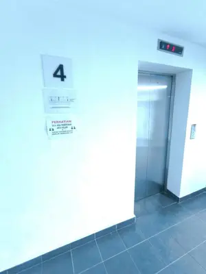 a elevator in a building with a sign on the wall at ZH Studio Apartment Gua Musang With WIFI dan POOL in Gua Musang