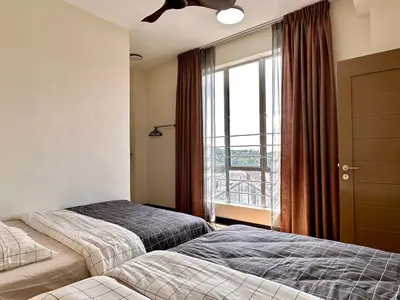 two beds in a hotel room with a window at Emerald Avenue Brinchang Muji style in Brinchang