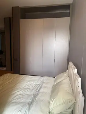 a bed with white cabinets in a bedroom at Luxury Seaview Private Elevator Near Island Hospital and Gurney plaza \u68b9\u57ce\u65e0\u654c\u6d77\u666f\u79c1\u4eba\u7535\u68af\u9760\u8fd1\u533b\u9662\u548c\u5546\u573a in Tanjong Tokong