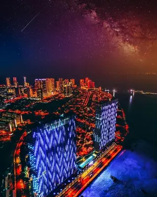 a view of a city at night with blue lights at Luxury Seaview Private Elevator Near Island Hospital and Gurney plaza \u68b9\u57ce\u65e0\u654c\u6d77\u666f\u79c1\u4eba\u7535\u68af\u9760\u8fd1\u533b\u9662\u548c\u5546\u573a in Tanjong Tokong