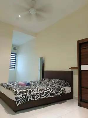 a bedroom with a zebra print bed in a room at Homestay Sitiawan 53 in Sitiawan