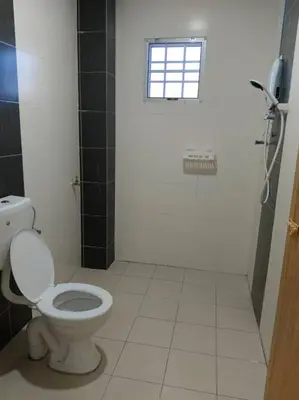 a bathroom with a toilet and a window at Homestay Sitiawan 53 in Sitiawan
