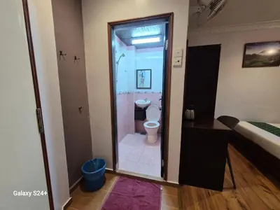 a bathroom with a shower and a toilet in a room at Hotel Sentosa in Brinchang