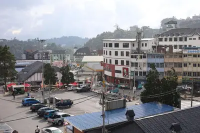 a city with cars parked in a parking lot at Hotel Sentosa in Brinchang