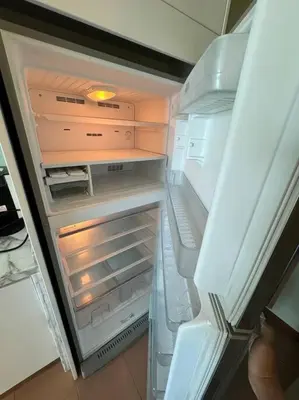 an empty refrigerator with its door open in a kitchen at 2Beds Seaview Waterfront Straits Quay w/Free Carpark And Bathub in Tanjong Tokong