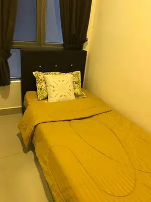 a yellow bed in a room with a window at Palas at Cameron Highland in Cameron Highlands