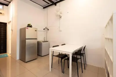 a kitchen with a white table and a refrigerator at Casa for 2 - Private Studio Ipoh in Ipoh