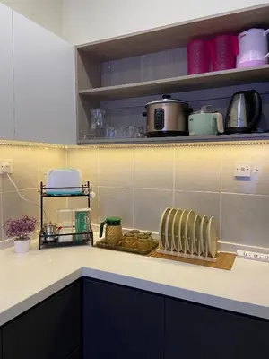 a kitchen counter with a radiator on a counter top at Homestay Khan'Da Teluk Intan in Teluk Intan