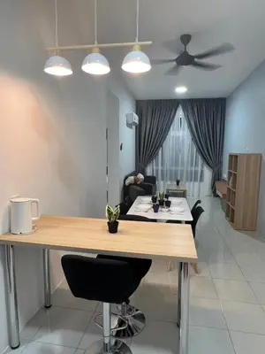 a living room with a table and a ceiling fan at Ipoh Town Anderson Haru Suite 7 paxs 2R2B in Ipoh