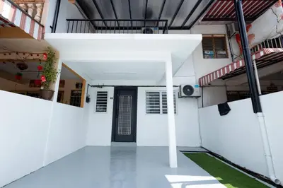 a hallway of a white building with a black door at Mono Ipoh - Bercham, 2 parking, sleep 10, Lost World Tambun in Ipoh