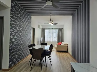 a dining room with a table and chairs and a couch at E! Best Apartment in Padang Serai