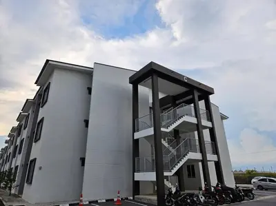 a building with motorcycles parked in front of it at E! Best Apartment in Padang Serai