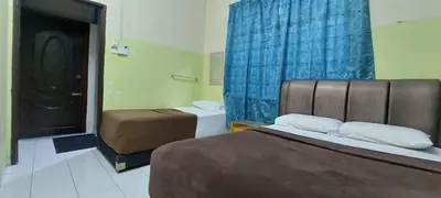 a hotel room with two beds and a bathroom at Sobey Laris Roomstay GUA MUSANG in Gua Musang