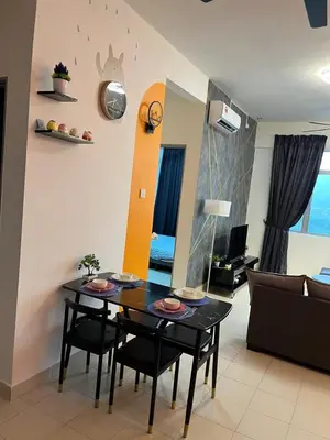 a dining room table and chairs in a living room at Ws Falim in Ipoh
