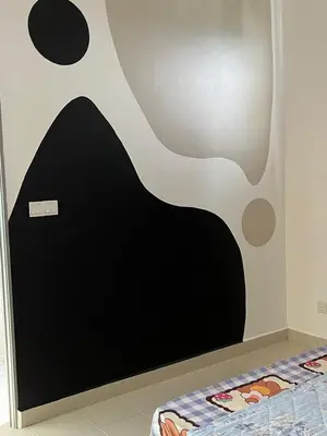 a bedroom with a black and white wall at Ws Falim in Ipoh