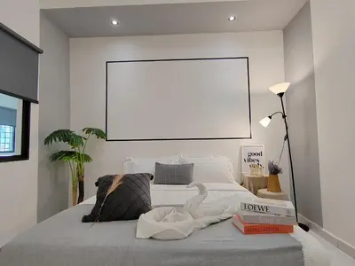a white room with a bed with a blank frame at Sunway Tambun Salesman Stay 5 Bedroom 10pax by IWH in Ipoh