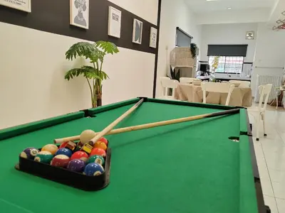 a pool table with two cue sticks and balls at Sunway Tambun Salesman Stay 5 Bedroom 10pax by IWH in Ipoh