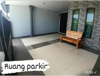 a room with a bench sitting on a tile floor at Homestay Mukhriz in Kulim