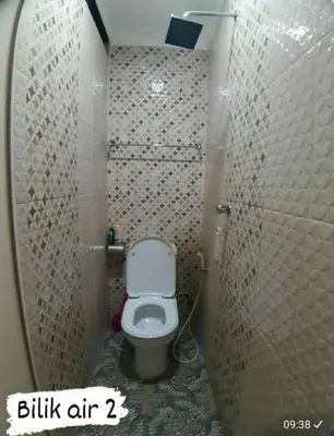 a small bathroom with a toilet in a stall at Homestay Mukhriz in Kulim