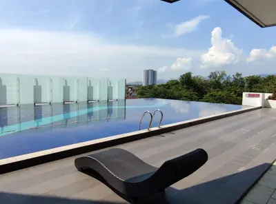 a chair on the roof of a building with a swimming pool at THE MAJESTIC IPOH A20 by ZamanJa in Ipoh