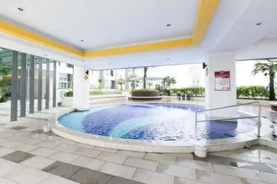 a swimming pool in the middle of a building at THE MAJESTIC IPOH A20 by ZamanJa in Ipoh
