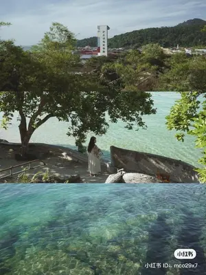 a woman standing in front of a body of water at Jo Jo Homestay @ Pangkor Coral Bay Resort in Pasir Bogak