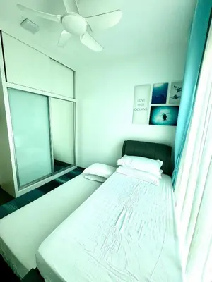 a bedroom with a bed and a window at Livistona Luxe Apartment in Permatang Pauh