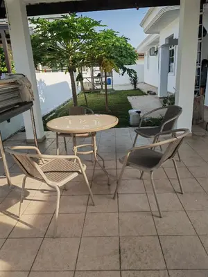 a table and chairs on a patio with a table at Padang Serai Roomstay Family Suite Share Bathroom804 in Padang Serai