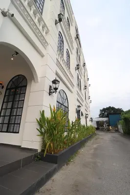 a white building with plants on the side of it at Casa Colney Hotel Ipoh in Ipoh