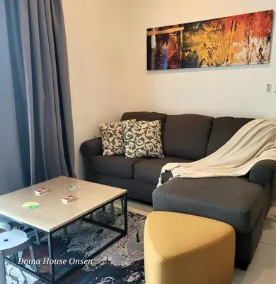 a living room with a couch and a table at Doma House Onsen at Sunway Onsen, Tambun in Ipoh