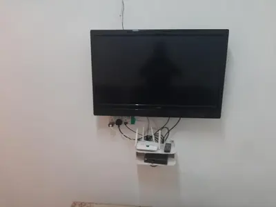 a flat screen tv hanging on a wall at DIAMOND HOMESTAY in Kuala Kangsar