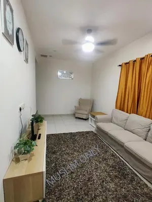 a living room with a couch and a table at Swedish Style Homestay in Teluk Intan