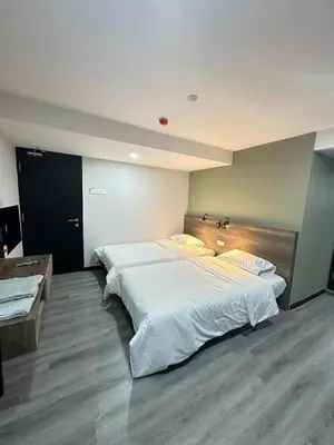 a large bedroom with a large white bed in it at EpochHotel in Taiping