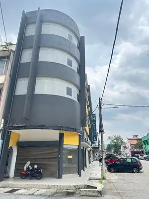 a building with a motorcycle parked in front of it at EpochHotel in Taiping
