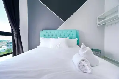 a bedroom with a white bed with white towels on it at Ben Cozy Executive Suite 3BR The Horizon Ipoh in Ipoh