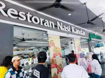 a group of people standing outside of a skateboard shop at Home in Simpang Ampat in Simpang Ampat
