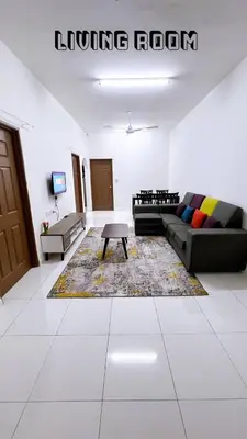 a living room with a couch and a coffee table at HomeSTAY D'Manjung Lumut in Lumut