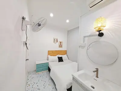 a bedroom with a bed and a sink and a mirror at HT Homestay BigSemi-D BBQwedding in town in Jelutong