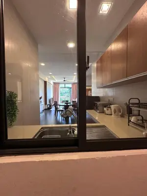 a large kitchen with a view of a living room at Adamhawa Homestay 2 Nova Cameron Highlands in Brinchang