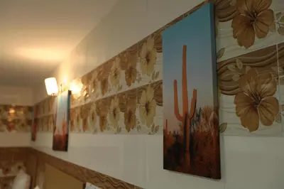 a wall with paintings of flowers and cactus at Cameron Kea Farm Hotel in Brinchang