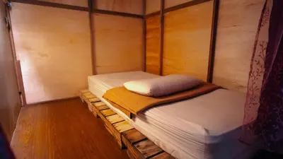 a small room with two twin beds in it at Jungle Ippie Hostel in Tanah Rata