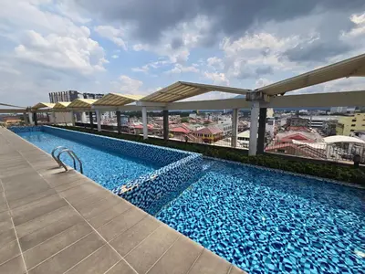 a swimming pool on the roof of a building at The Octagon Ipoh City Centre Leisure Suite in Ipoh