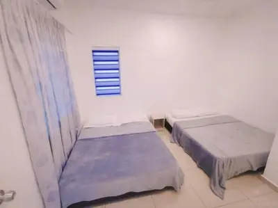 two beds in a white room with a window at 90 Home4Stay 2storeySemi-D gurney&beach Shopping local food in Tanjung Bungah