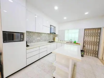 a white kitchen with white cabinets and a counter at 90 Home4Stay 2storeySemi-D gurney&beach Shopping local food in Tanjung Bungah