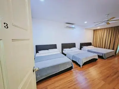 three beds in a room with wooden floors at 90 Home4Stay 2storeySemi-D gurney&beach Shopping local food in Tanjung Bungah