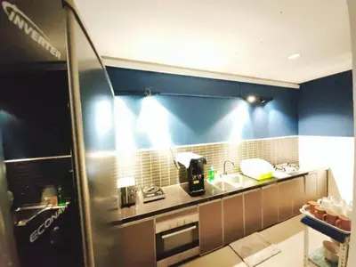 a kitchen with a sink and a refrigerator at 12 George town 6room terrace gurney heritage adventist hospital restaurant shopping mall in George Town