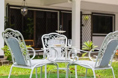 three white chairs and a table in front of a house at 35 Home4Stay Tanjong Bungalow Wedding BBQ Near Beach restaurant in Tanjung Bungah