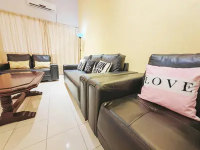 a living room with two leather chairs and a table at 7 Home4Stay Peaceful GurneyTerrace 4BR15pax Shops & Eateries in George Town