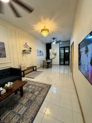 a living room with a couch and a tv at D’Puteri Homestay Bidor in Bidur