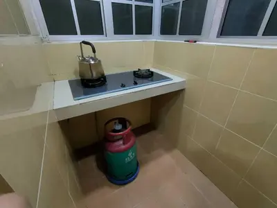 a small stove in a corner of a room at Centrum Homestay in Cameron Highlands